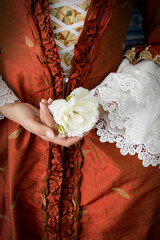 18th-Century woman wearing a silk robe a la Francaise and holding a large ostrich feather fan 