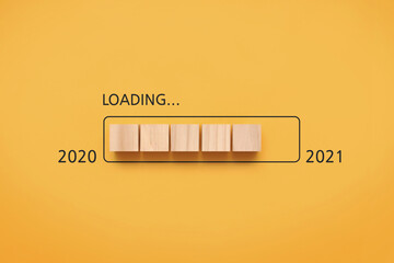 Wooden cubes with a bootable battery and the words: 2020 to 2021. Coming soon in 2021