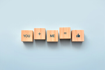 Wooden cubes with the inscription: you and me - it's beautiful. Love and friendship in relationships