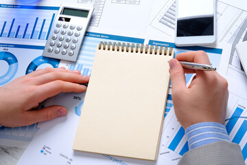 Fototapeta premium Businessman works at his desk. Business items on the table.