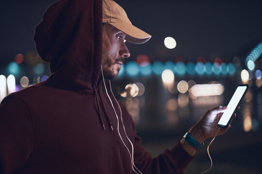 Athletic sporty man training in hoodie sweatshirt in urban / city environment.