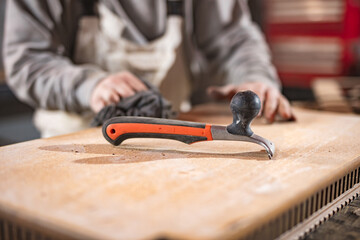 Male carpenter working on old wood in a retro vintage workshop.