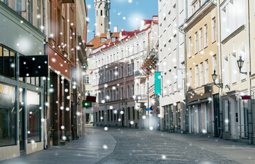 Fototapeta na wymiar architecture and urban concept - empty street of Tallinn city old town over snow