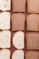 View from above on fresh white and black bread, sliced into even pieces