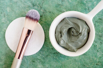 Gray (green) bentonite clay in the bowl. Clay texture close up. Diy mask and body wrap recipe....