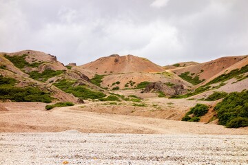 Icelandic landscape with red and orange hills in Lonsoraefi in overcast weather
