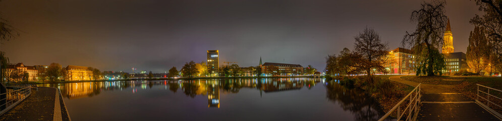 Fototapeta na wymiar Panoramic view of Kiel skyline, Kiel Opera House, the town Hall by Kleiner Kiel by night.