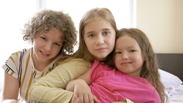 Portrait of three smiling girls. Fun pajama party for girls from 5 to 11 years old.