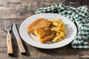 San Jacobo steak filled with cheese and ham on wooden table	