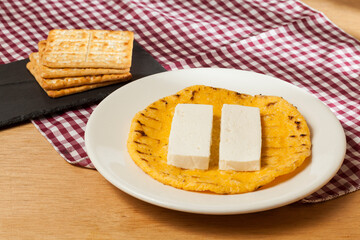 Tasty traditional breakfast in Colombia; Arepa of yellow corn with cheese.