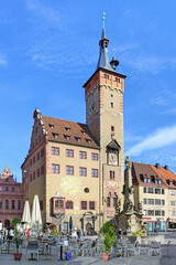 Obraz premium Wurzburg, Germany. Grafeneckart - the oldest part of Town Hall (Altes Rathaus), and Four tube wells (Vierrohrenbrunnen) - one of the most famous fountains in the city. 