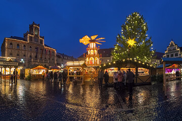 Weimar, Germany. Panoramic view of Christmas market at Market Square in dusk. The neo-Gothic Town...