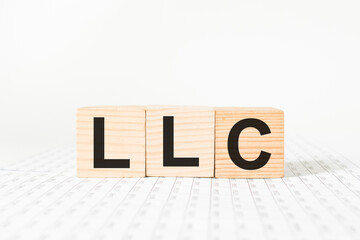 word LLC on wooden blocks, white background, business concept. business and Finance