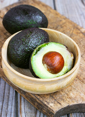 food background with fresh organic avocado on old wooden table, top view, copy space