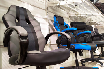 Different computer gamer soft ergonomic chairs in the furniture store.