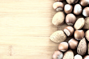 Walnuts and other nuts on a wooden board.