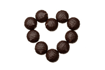 Heart from chocolate sweets, marshmallows in chocolate isolated top view. The concept of congratulations, love of sweets. Close-up photo. Happy Valentine's day
