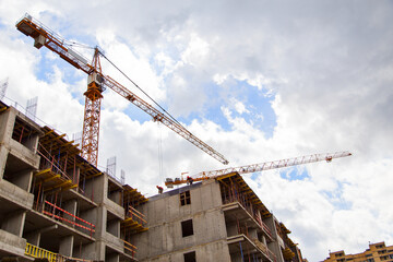 Construction of apartment buildings in a new neighborhood with tower cranes .Horizontally.