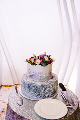 White and grey wedding cake with flowers for wedding banquet. Delicious wedding reception. Copy space. Celebration party concept. Trendy Cake.