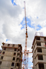 Construction of apartment buildings in a new neighborhood with tower cranes .Vertically.