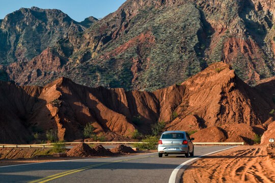car on the road in mountains cafayate
