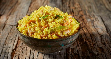 Bowl of saffron flavored couscous and quinoa