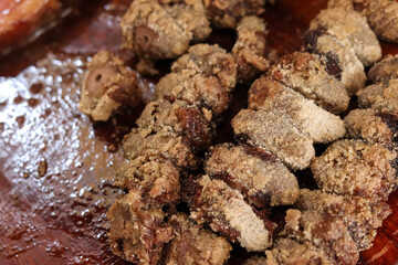 Chicken heart made on skewers, traditional food on barbecue.