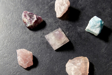 occult science, minerals and geology concept - quartz crystal pyramid and gem stones on slate...