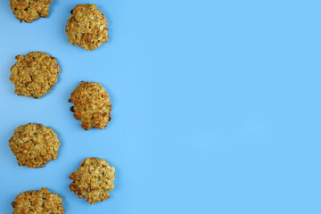 homemade oatmeal cookies with raisins on a blue background. Copy space for text