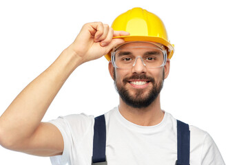 profession, construction and building - happy smiling male worker or builder in yellow helmet and overall over white background
