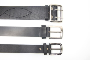 three black leather belt on white background