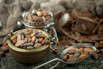 Cocoa beans, on old background.