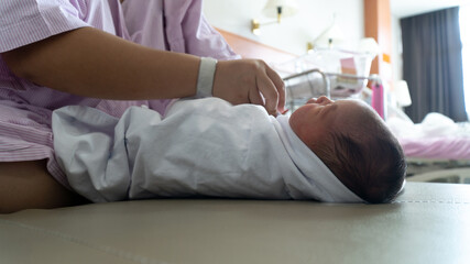 Obraz na płótnie Canvas New Born Baby Girl is New Born Baby GIrl Being Wrapped