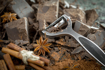 Dark chocolate in a composition with cocoa beans and nuts, on an old background.