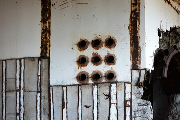 A fragment outside the unfinished reactor block of a nuclear power plant in Crimea. A hole in the wall with exposed rebar.