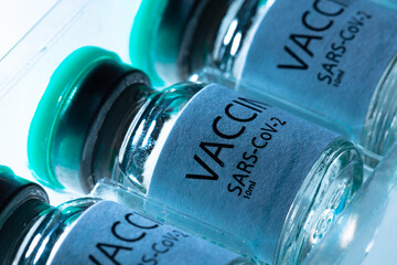 Vaccine vial of Sars-cov-2 on table in laboratory