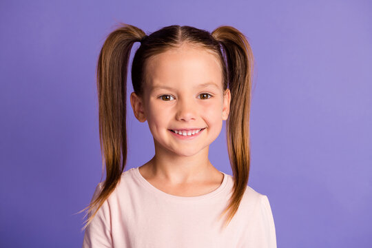 Photo of cute pretty small little girl beaming nice smile good mood isolated on violet color background