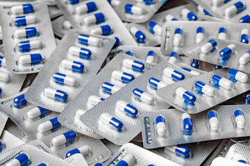 Blue and white capsule pills in blister packs