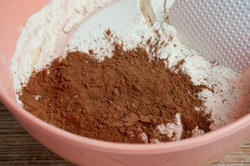 kneading dough, flour, cocoa in a bowl