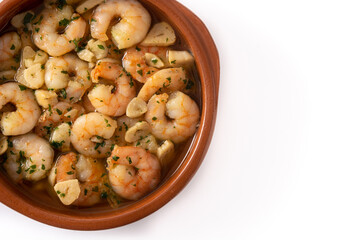 Garlic prawns in crock pot isolated on white background	. Top view. Copy space