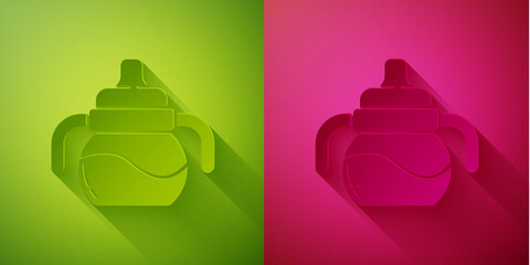 Paper cut Baby bottle icon isolated on green and pink background. Feeding bottle icon. Milk bottle sign. Paper art style. Vector.