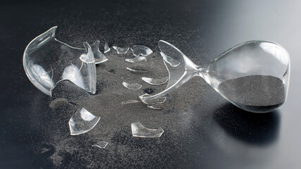 broken hourglass. waste of time. end of opportunity. stop measuring hours. shards of glass....