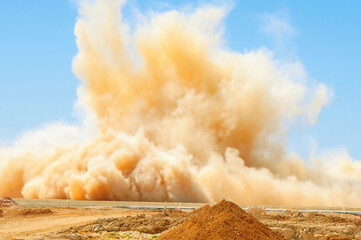 Dust storm after detonator blast in the desert