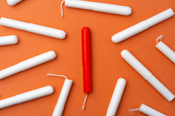 Medical female tampons on orange background top view