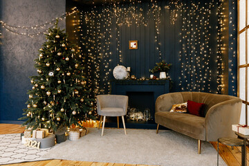Christmas tree decorated in the interior with gifts and garlands near the fireplace. Stylish interior in dark and gold tones, decorated for the New Year.