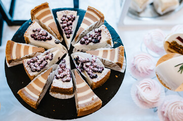 Sweet table. A plates of cakes and muffins. Table with sweets, buffet. Dessert table for a party goodies. Party reception, decorated delicious in restaurant. Candy bar. Top view.