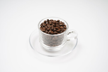Coffee beans in transparnet cup isolated on white background 