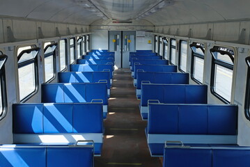 Obraz premium Empty train carriage with blue seats