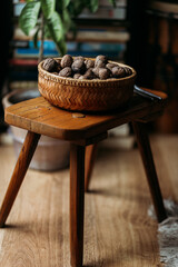 walnuts in wooden bowl on the wooden chair
