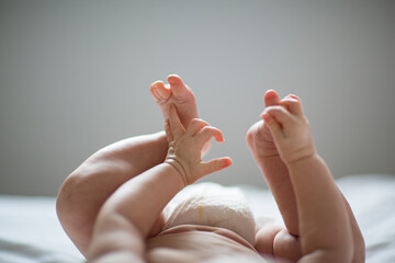 legs and hands of baby lying on back